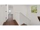 Second floor hallway with wood floors, natural light and a staircase at 306 Cecil St, Durham, NC 27707