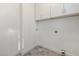 Laundry room with tile floors, utility hookups and a white cabinet above at 306 Cecil St, Durham, NC 27707