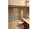 Standard bathroom featuring a fiberglass shower-tub combo with sliding door, a vanity with wood drawers, and a toilet at 310 Meadowbrook Dr, Burlington, NC 27215