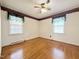 Bright bedroom with gleaming hardwood floors and neutral wall paint at 310 Meadowbrook Dr, Burlington, NC 27215