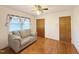 Inviting bedroom featuring hardwood floors and a comfortable grey sofa at 310 Meadowbrook Dr, Burlington, NC 27215