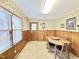 Cozy eat-in dining area with wood paneling and a wooden table and chairs at 310 Meadowbrook Dr, Burlington, NC 27215