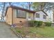 Charming brick and siding home with lovely front yard landscaping and light blue shutters and trim at 3416 North Ridge Dr, Sanford, NC 27330