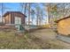 View of the backyard area, showing a shed and brick retaining walls at 3416 North Ridge Dr, Sanford, NC 27330