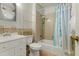 Cozy bathroom featuring a shower-tub combination with blue curtain and a white vanity sink at 3416 North Ridge Dr, Sanford, NC 27330