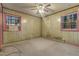 This bedroom features wood paneling, two windows, and a ceiling fan with lights at 3416 North Ridge Dr, Sanford, NC 27330