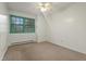 Bright bedroom with white walls, carpet flooring, ceiling fan, and a large window at 3416 North Ridge Dr, Sanford, NC 27330