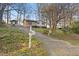Single-story home on a sloping lot with mature trees, accessed by a paved driveway at 3416 North Ridge Dr, Sanford, NC 27330