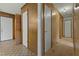 Hallway featuring carpet and patterned vinyl flooring and paneled walls and multiple doors at 3416 North Ridge Dr, Sanford, NC 27330