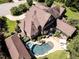 An expansive property boasts a sparkling pool and outdoor kitchen visible from an aerial perspective of the home at 3505 Jonaway Cir, Fuquay Varina, NC 27526