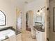 Luxurious bathroom with a soaking tub, marble countertop, vanity, and walk-in shower at 3505 Jonaway Cir, Fuquay Varina, NC 27526