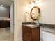 Charming bathroom featuring granite countertop, bronze fixtures, and decorative mirror at 3505 Jonaway Cir, Fuquay Varina, NC 27526