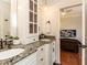 Bathroom with double sink vanity, granite counters, and decorative mirror at 3505 Jonaway Cir, Fuquay Varina, NC 27526
