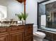 Bathroom featuring granite counters, glass shower, tile, and vanity with decorative mirror at 3505 Jonaway Cir, Fuquay Varina, NC 27526