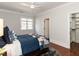 Bedroom with ceiling fan, closet, window, hardwood floors, and cozy bed at 3505 Jonaway Cir, Fuquay Varina, NC 27526