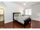 Bedroom with hardwood floors, window, closet, and comfortable bed with decorative pillows at 3505 Jonaway Cir, Fuquay Varina, NC 27526