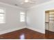 Bright bedroom with hardwood floors, closet, ceiling fan, and windows at 3505 Jonaway Cir, Fuquay Varina, NC 27526