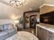 Inviting bonus room features shiplap walls, wet bar, TV, and comfy seating at 3505 Jonaway Cir, Fuquay Varina, NC 27526