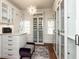 Designer closet with glass-front cabinets, built-in shelving, chandelier, and ample storage space at 3505 Jonaway Cir, Fuquay Varina, NC 27526