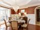 Sophisticated dining room with a crystal chandelier, rich wood floors, and elegant wallpaper for refined entertaining at 3505 Jonaway Cir, Fuquay Varina, NC 27526