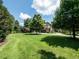 Well-manicured front lawn, mature trees, and inviting curb appeal creating a welcoming entrance at 3505 Jonaway Cir, Fuquay Varina, NC 27526
