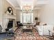 Inviting living room with a stone fireplace, bay window, and custom millwork, perfect for relaxation and gatherings at 3505 Jonaway Cir, Fuquay Varina, NC 27526
