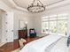 Spacious main bedroom with hardwood floors, natural light, and an accent chair at 3505 Jonaway Cir, Fuquay Varina, NC 27526