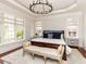 Serene main bedroom featuring a large window, chandelier, and wood accents at 3505 Jonaway Cir, Fuquay Varina, NC 27526