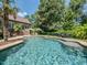 Backyard pool area with lush landscaping, lounge chairs, and outdoor dining at 3505 Jonaway Cir, Fuquay Varina, NC 27526