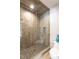 Modern shower with glass enclosure, mosaic tile accents, and sleek hardware for a luxurious experience at 3505 Jonaway Cir, Fuquay Varina, NC 27526