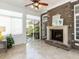 Bright sun room featuring a fireplace with stone surround, tiled floor, and access to outdoor space at 3505 Jonaway Cir, Fuquay Varina, NC 27526
