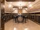 Unique wine cellar featuring custom racks, wood beams, and a barrel table at 3505 Jonaway Cir, Fuquay Varina, NC 27526