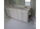 Bathroom featuring a bright double sink vanity, chrome fixtures and white tile floors at 3537 Layton Ridge Dr, Apex, NC 27539
