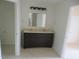 Bathroom featuring double sink vanity with dark wood cabinets and neutral countertop at 3537 Layton Ridge Dr, Apex, NC 27539