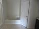 Bright bathroom showing tiled floor and a door separating a tub area at 3537 Layton Ridge Dr, Apex, NC 27539