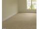 A sunlit bedroom with neutral carpet and a window overlooking greenery at 3537 Layton Ridge Dr, Apex, NC 27539