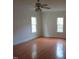 Spacious bedroom with gleaming hardwood floors, windows providing lots of light, and crown molding at 3537 Layton Ridge Dr, Apex, NC 27539