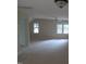Carpeted bonus room with ceiling fan and natural light from multiple windows at 3537 Layton Ridge Dr, Apex, NC 27539