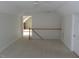 Bonus room area with white trim, ceiling fan, door, and railing at 3537 Layton Ridge Dr, Apex, NC 27539