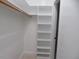Walk-in closet featuring a built-in shelving unit and a wooden clothes rod at 3537 Layton Ridge Dr, Apex, NC 27539