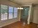 Bright dining area with large windows, hardwood floors, and elegant chandelier at 3537 Layton Ridge Dr, Apex, NC 27539