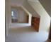 A carpeted hallway leading to an open area with a built-in bookshelf at 3537 Layton Ridge Dr, Apex, NC 27539