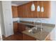 Kitchen island with stainless steel sink, granite countertops, and decorative pendant lights at 3537 Layton Ridge Dr, Apex, NC 27539