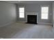 Bright living room features a fireplace and natural light from two windows at 3537 Layton Ridge Dr, Apex, NC 27539