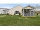 A spacious and well-manicured backyard featuring a screened-in porch at 408 Indian Elm Ln, Cary, NC 27519