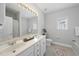 Bright bathroom with double sink vanity, framed mirror and garden tub at 408 Indian Elm Ln, Cary, NC 27519