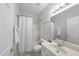 Cozy bathroom featuring a sink with cabinets and a shower with white curtain at 408 Indian Elm Ln, Cary, NC 27519