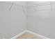Empty walk-in closet featuring a metal rack and neutral carpeting at 408 Indian Elm Ln, Cary, NC 27519