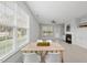 Open-concept dining area with a dining table and views of the fireplace and backyard at 408 Indian Elm Ln, Cary, NC 27519