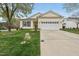 Inviting home with a well-maintained lawn, concrete driveway, and attached two-car garage at 408 Indian Elm Ln, Cary, NC 27519